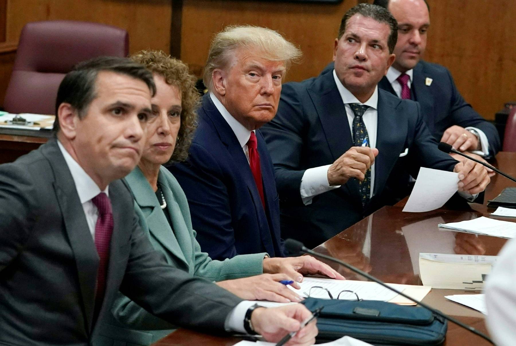 Epaule voûtées, lévres pincées, Trump dans la position de l'accusé